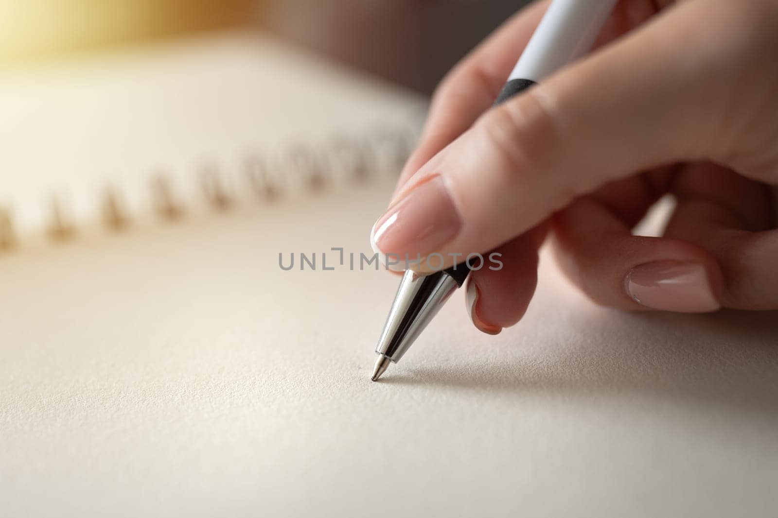 Hand of woman holding pen writing on notebook. Education and working concept. High quality photo