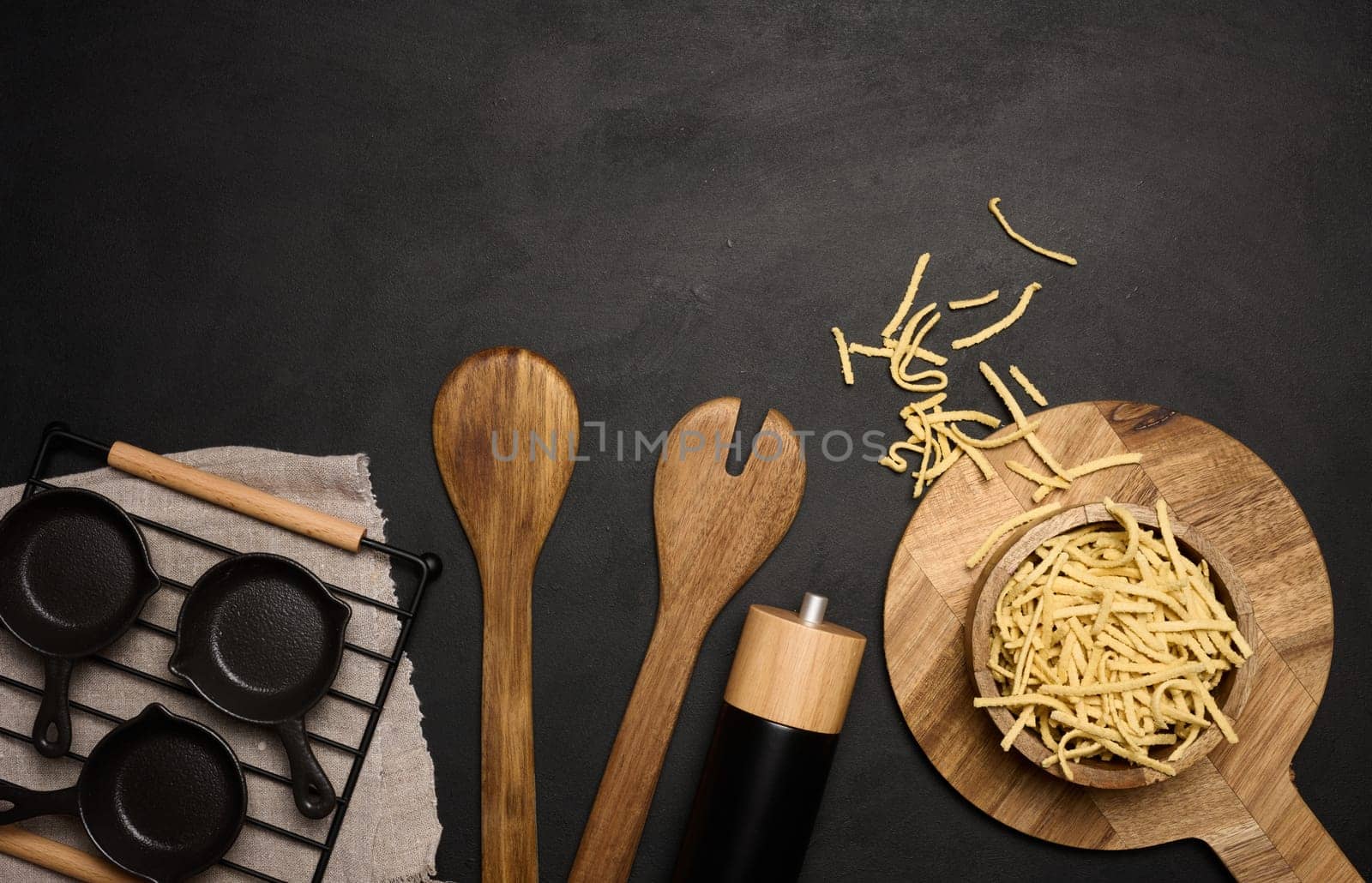 Raw wheat noodles in wooden bowl, top view by ndanko