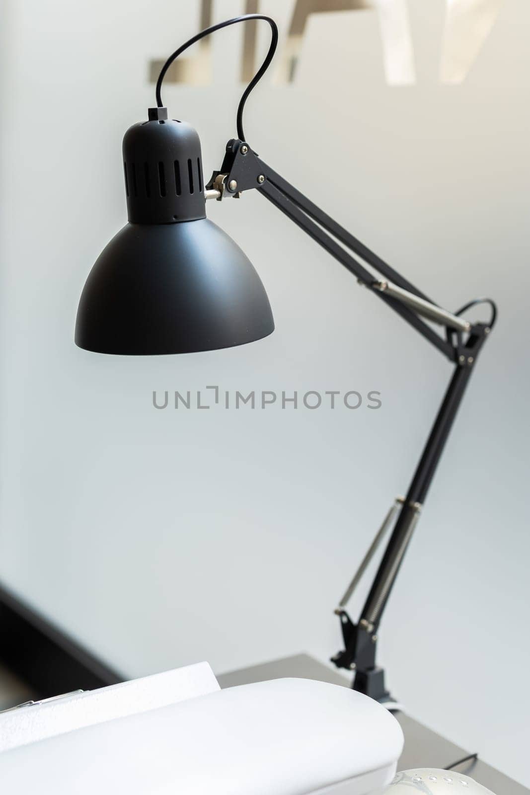 Vintage black desk lamp in nails business salon.