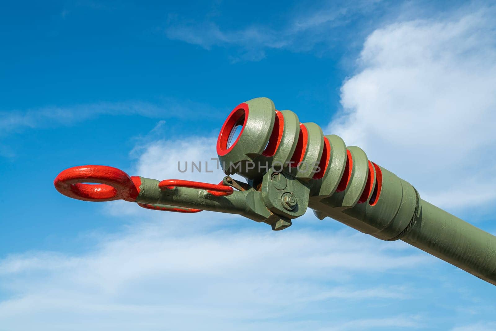 the barrel of an artillery piece against a blue sky background. photo