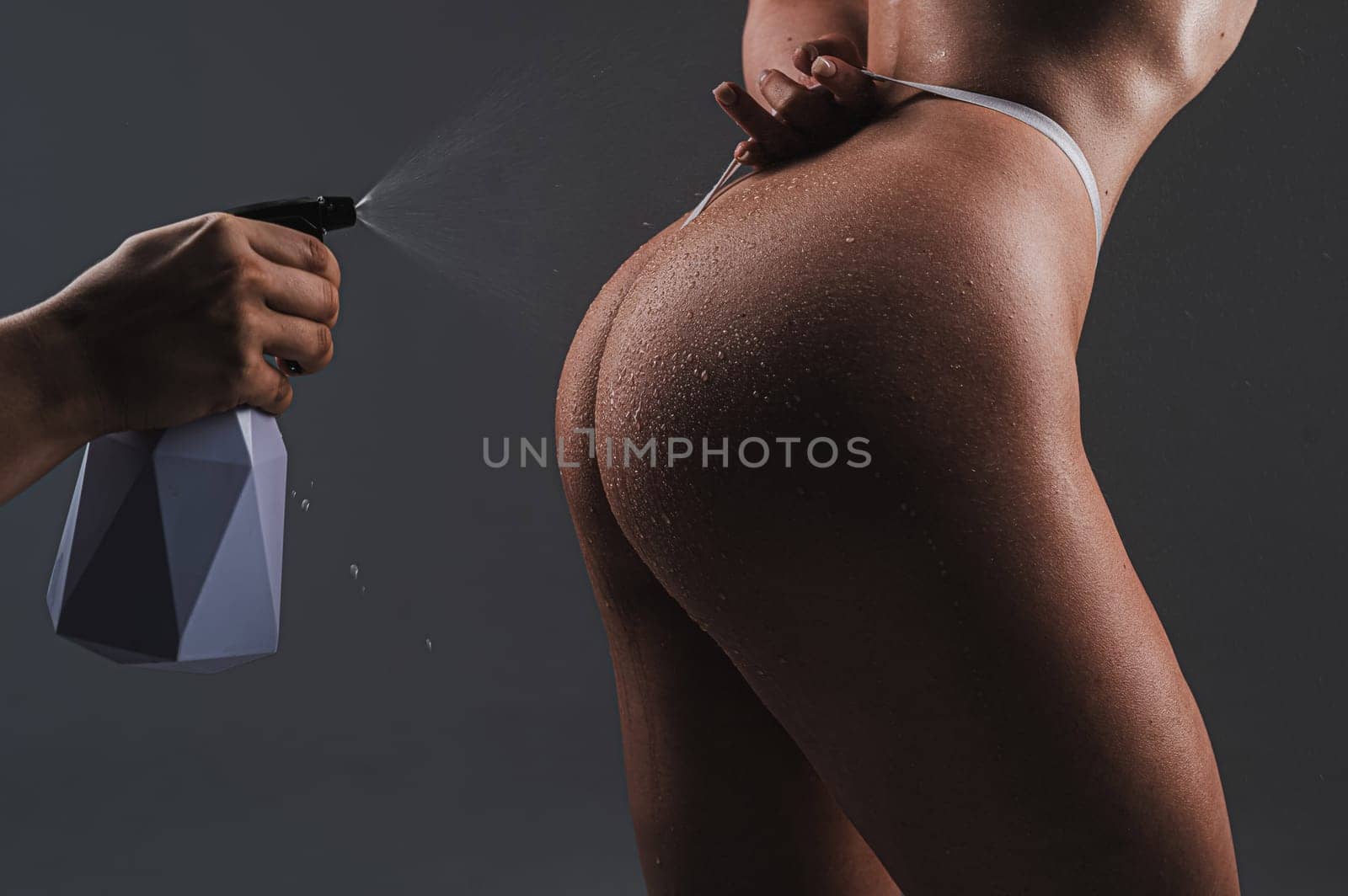 A faceless man sprays water from a polyerizer onto a woman's buttocks. by mrwed54