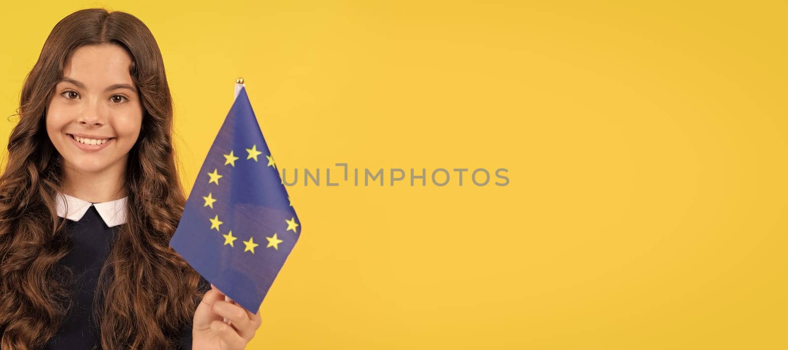 cheerful teen girl hold european union and german flag yellow background, travel. Horizontal poster of isolated child face, banner header, copy space. by RedFoxStudio