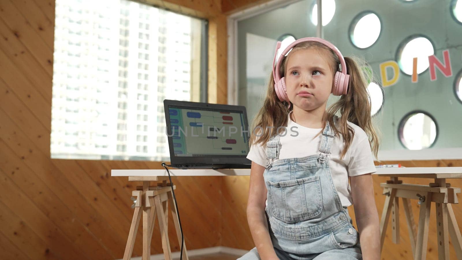 Caucasian tired girl bored while laptop screen display engineering prompt programing code. Pretty smart student with headphone asking or talking about science technology in STEM education. Erudition.