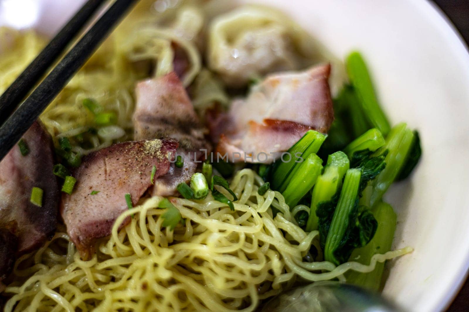 Egg noodle with wonton and red roasted pork. Asian food style.