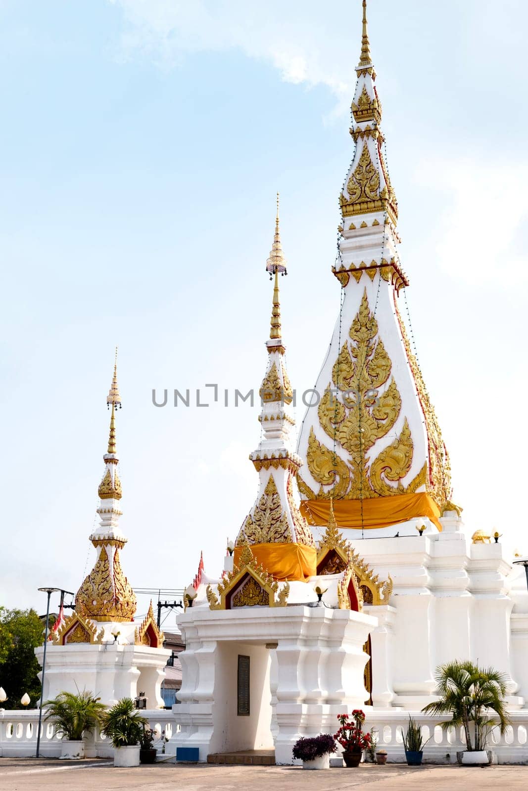 White pagoda and a building with the sky background.