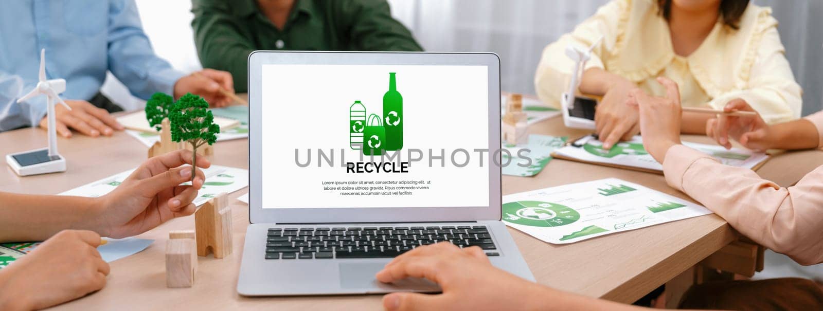 Recycle packaging displayed on laptop at a green business meeting while business team presenting green design. ESG environment social governance and Eco conservative concept. Closeup. Delineation.