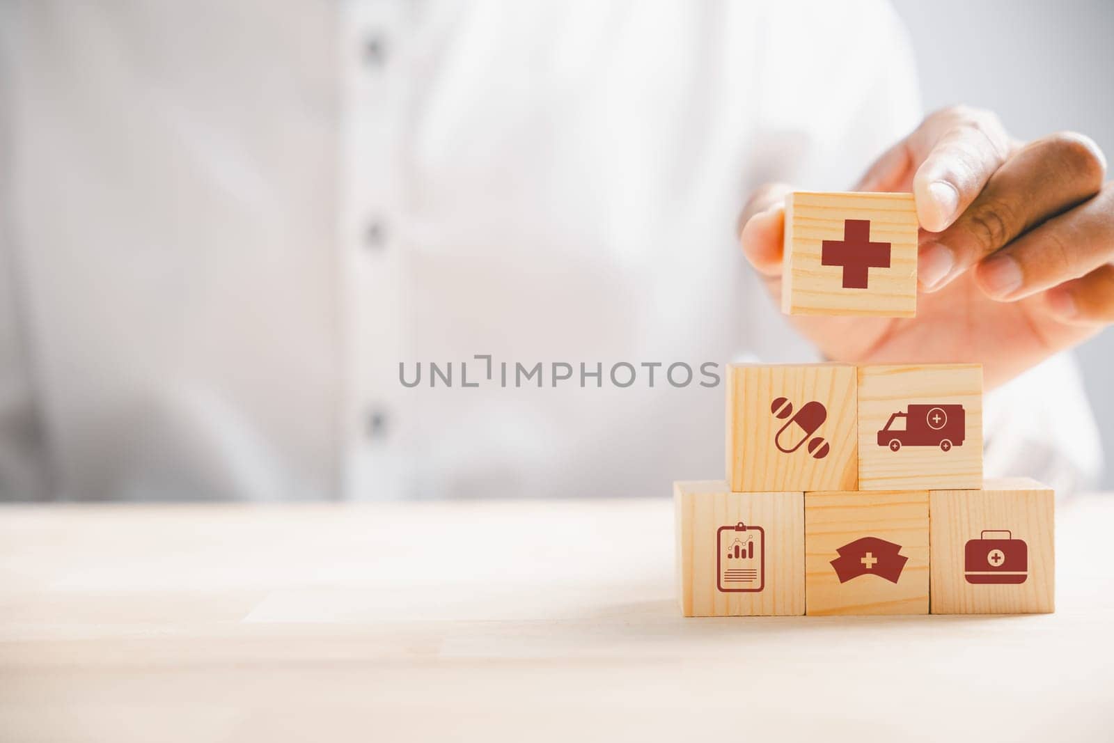 Hand hold wooden block with icon healthcare medical by Sorapop