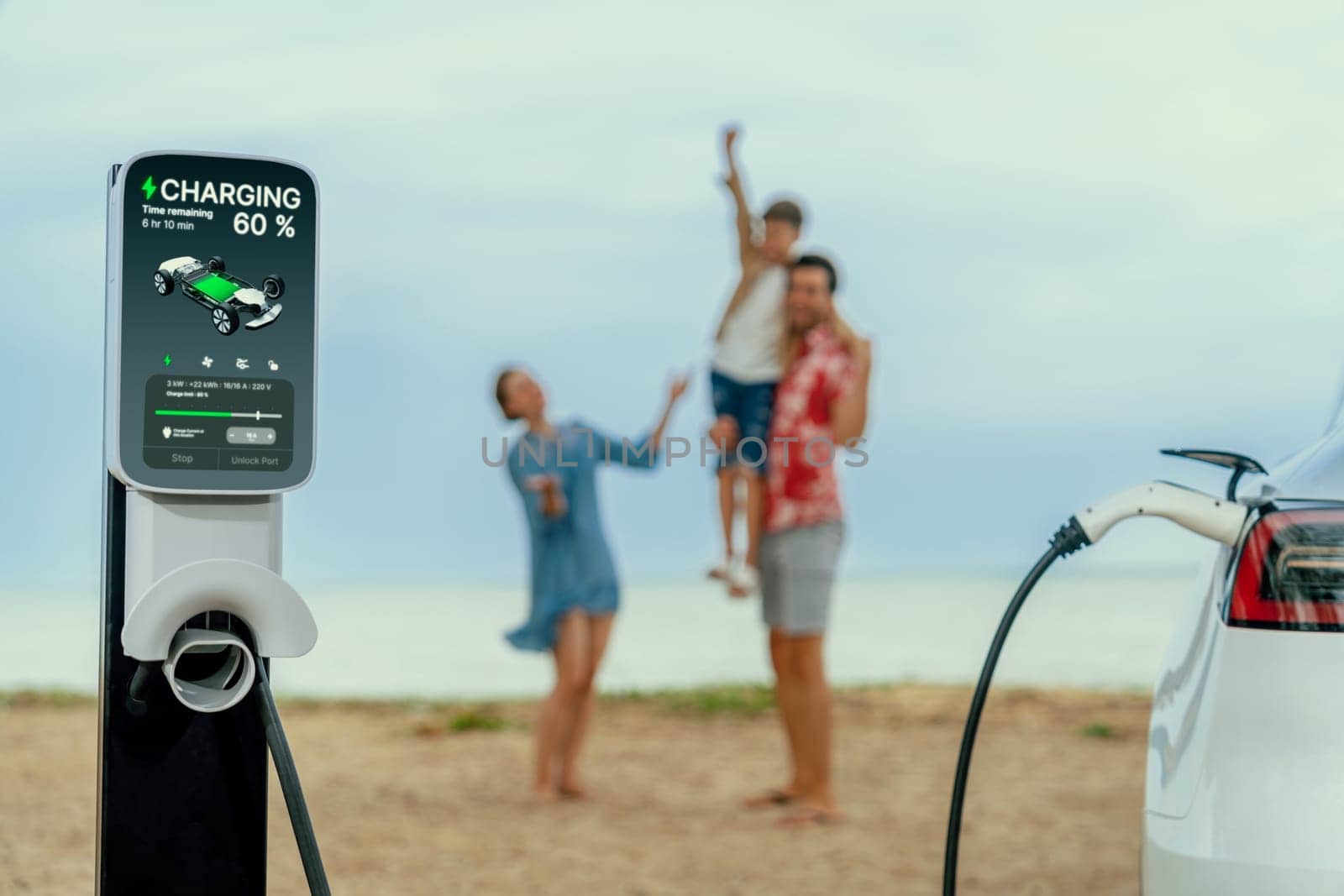 Alternative family vacation trip traveling by the beach with electric car recharging battery from EV charging station with blurred cheerful and happy family enjoying the seascape background. Perpetual