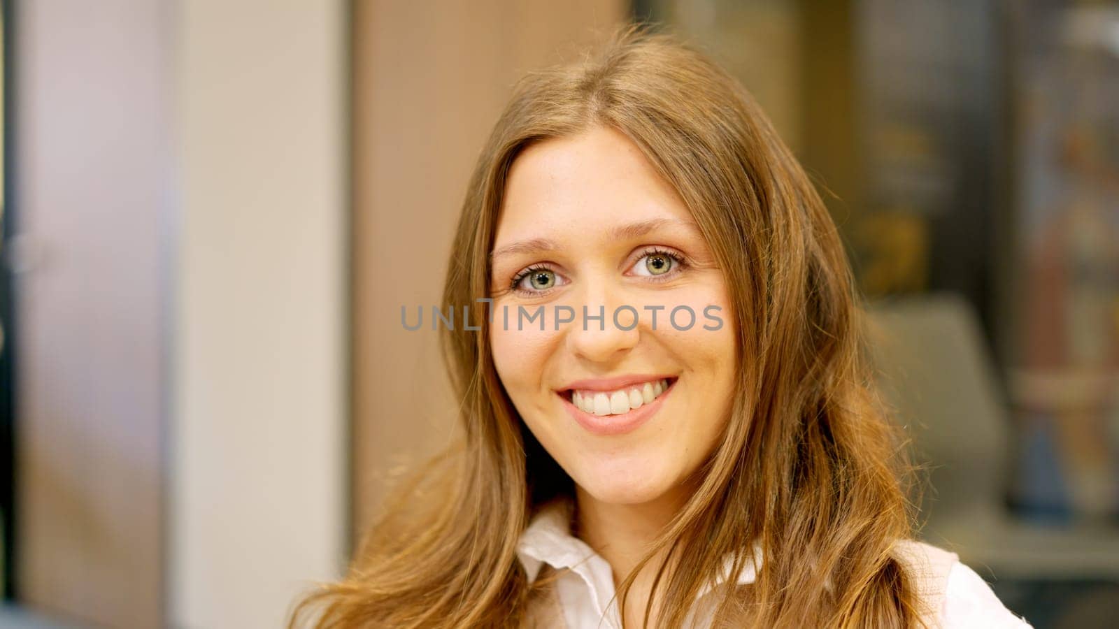 A young female coworker smiling at camera in the office