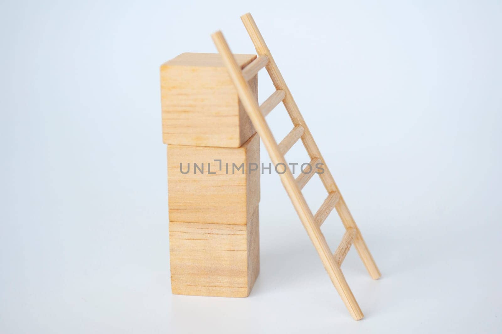 Wooden cubes with ladder on white background with customizable space for text