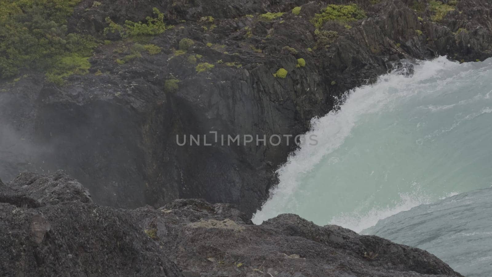 Turquoise Glacier Waterfall in Misty Canyon Under Soft Rain by FerradalFCG