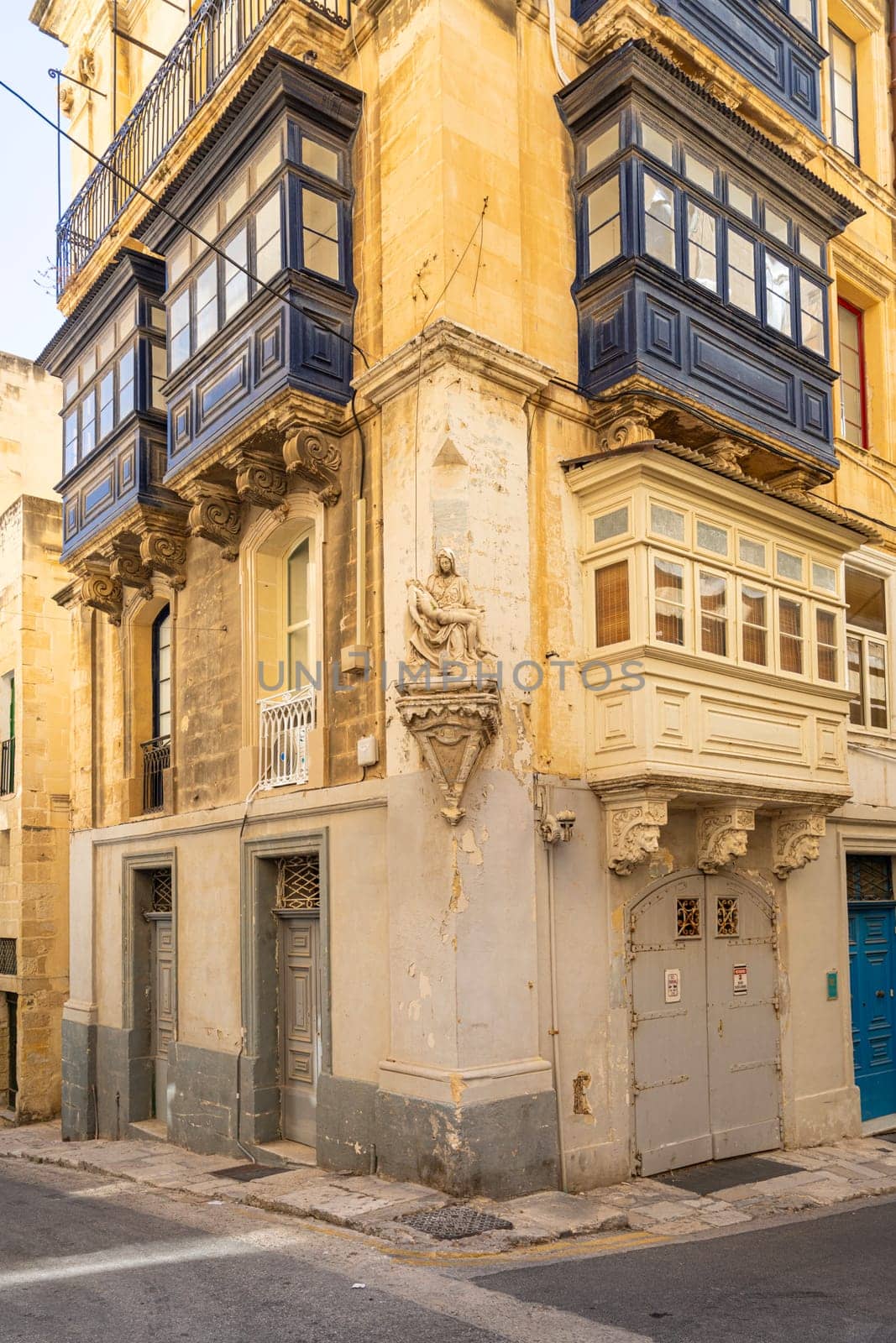 Valletta, Malta, April 03, 2024.  the typical religious statues at the corners of the ancient buildings and the city centre