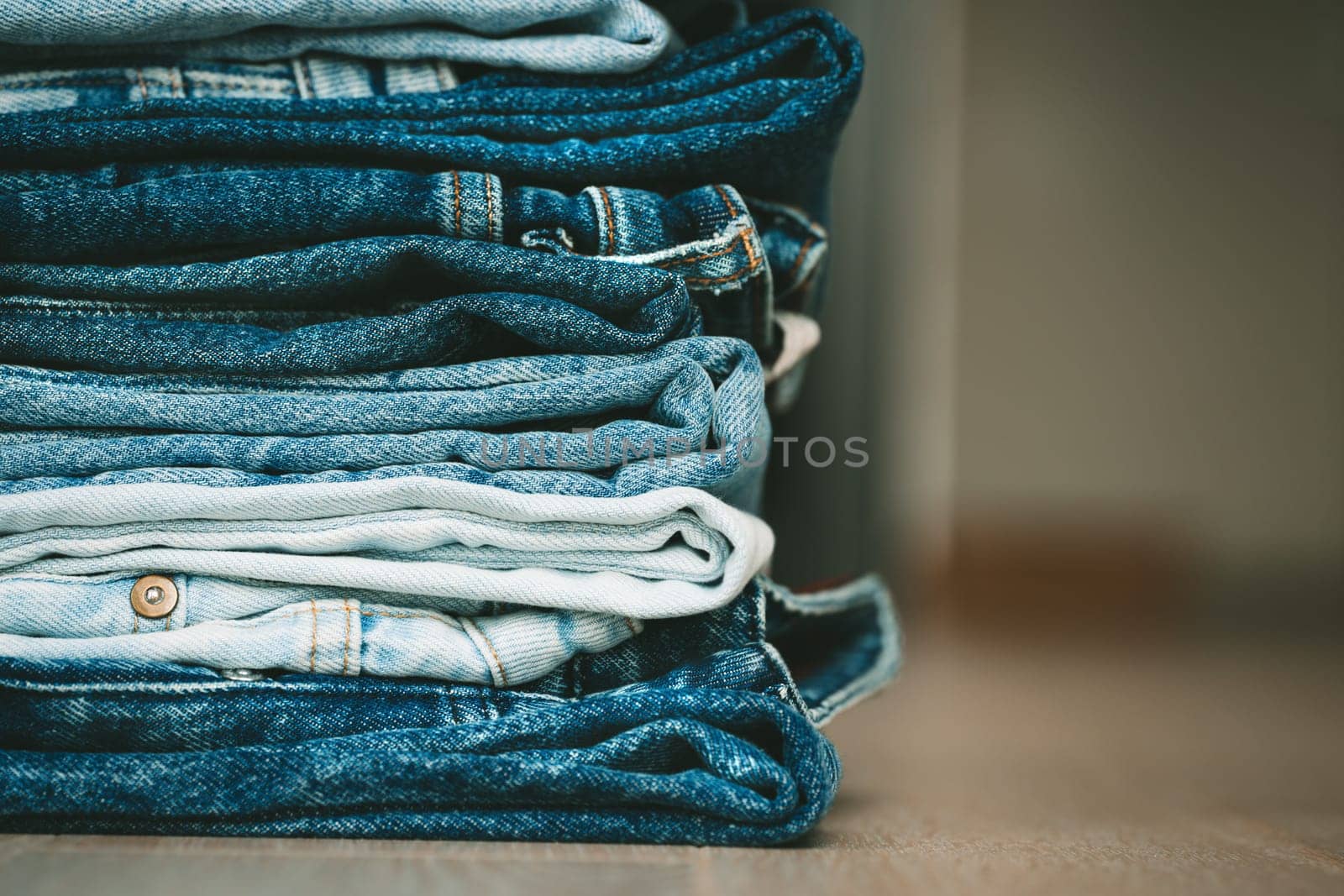Stack of folded denim pants. Fashion, style, stock and store concept. by DariaKulkova