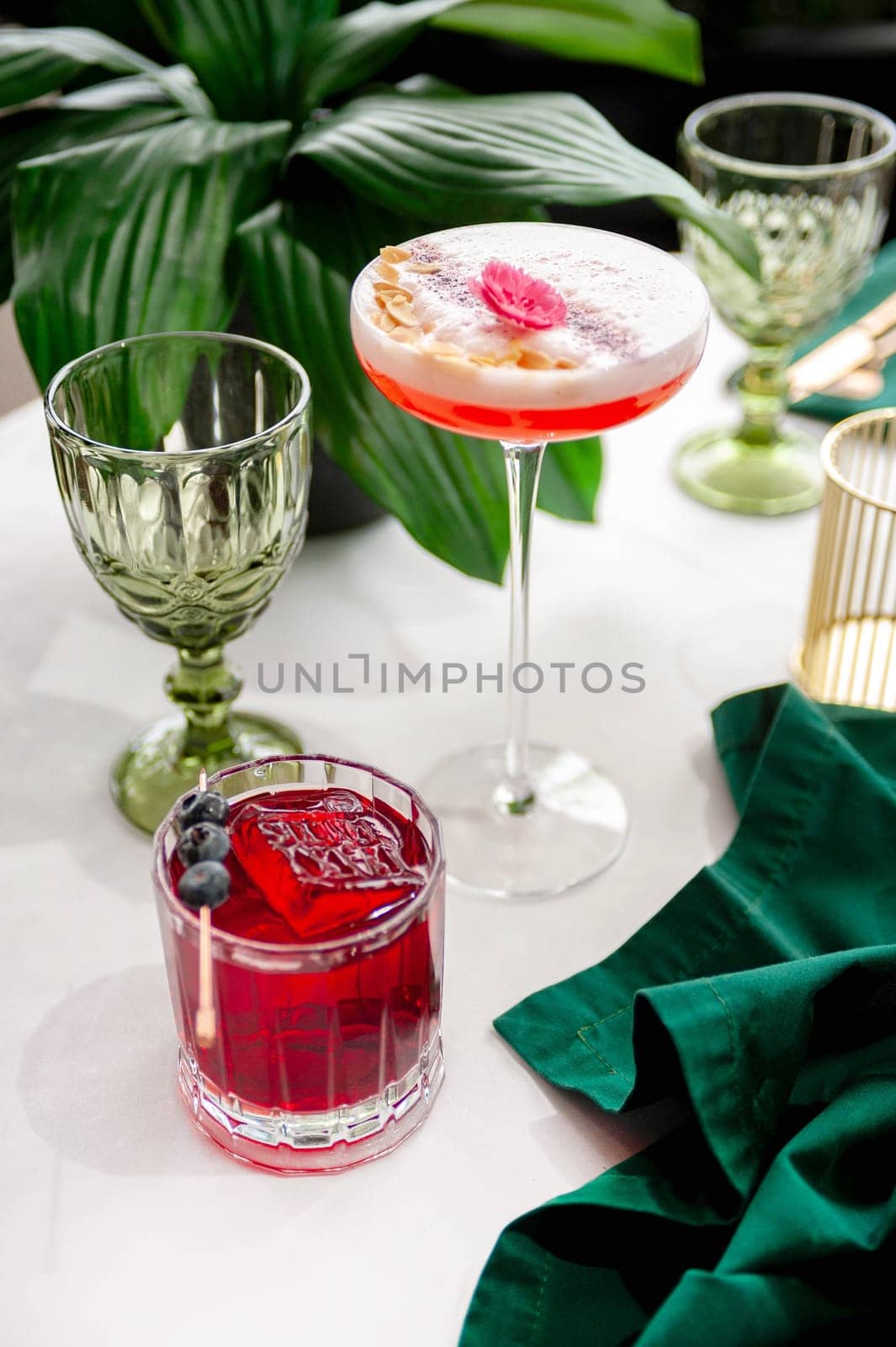 Two refreshing summer cocktails with lemon, mint, cranberry on a table. High quality photo