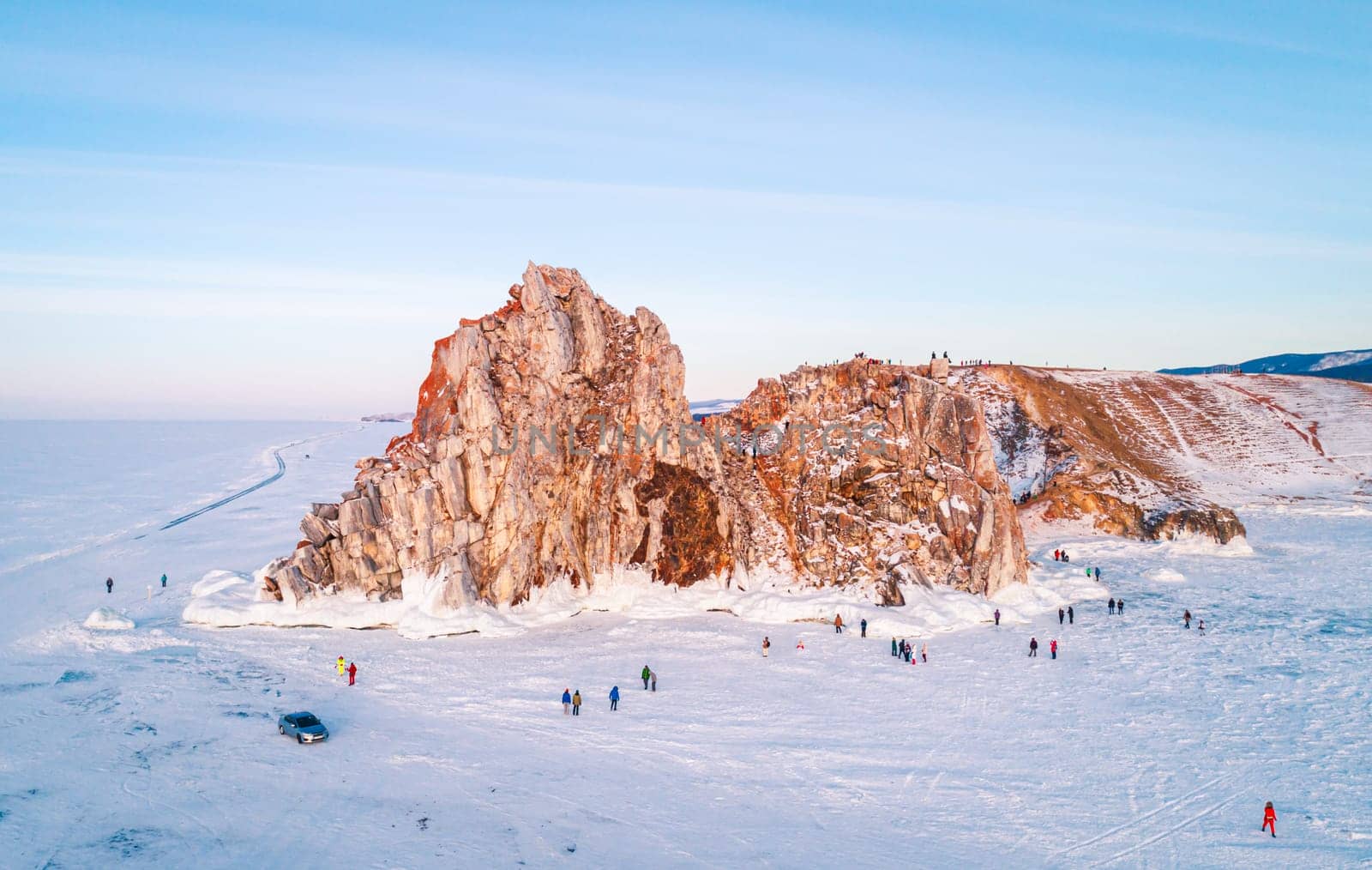 Aerial shot of a Shamanka rock on Olkhon island at sunset. Winter landscape. Popular touristic destination. Natural landmark. Panoramic view by Busker