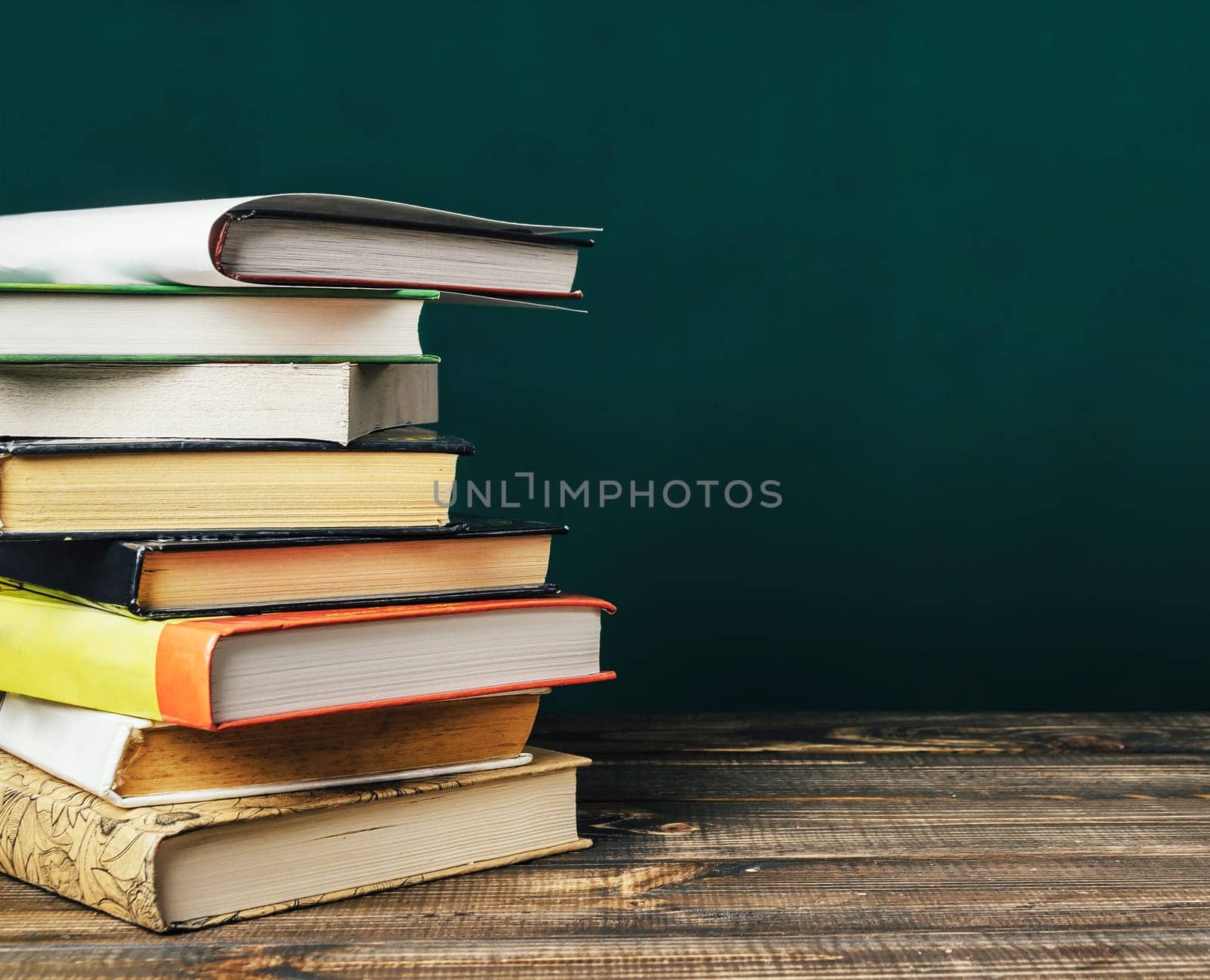 A stack of books on a wooden table by Alla_Morozova93