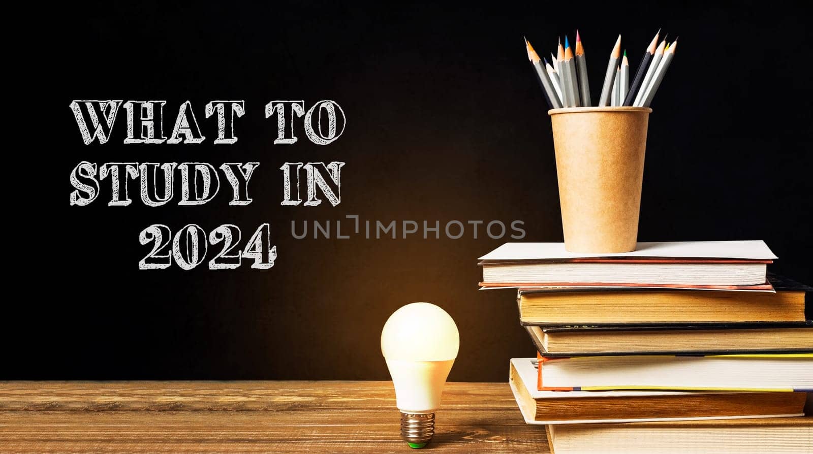 A stack of books and a light bulb on a table with the words What to Study in 2024 written above it