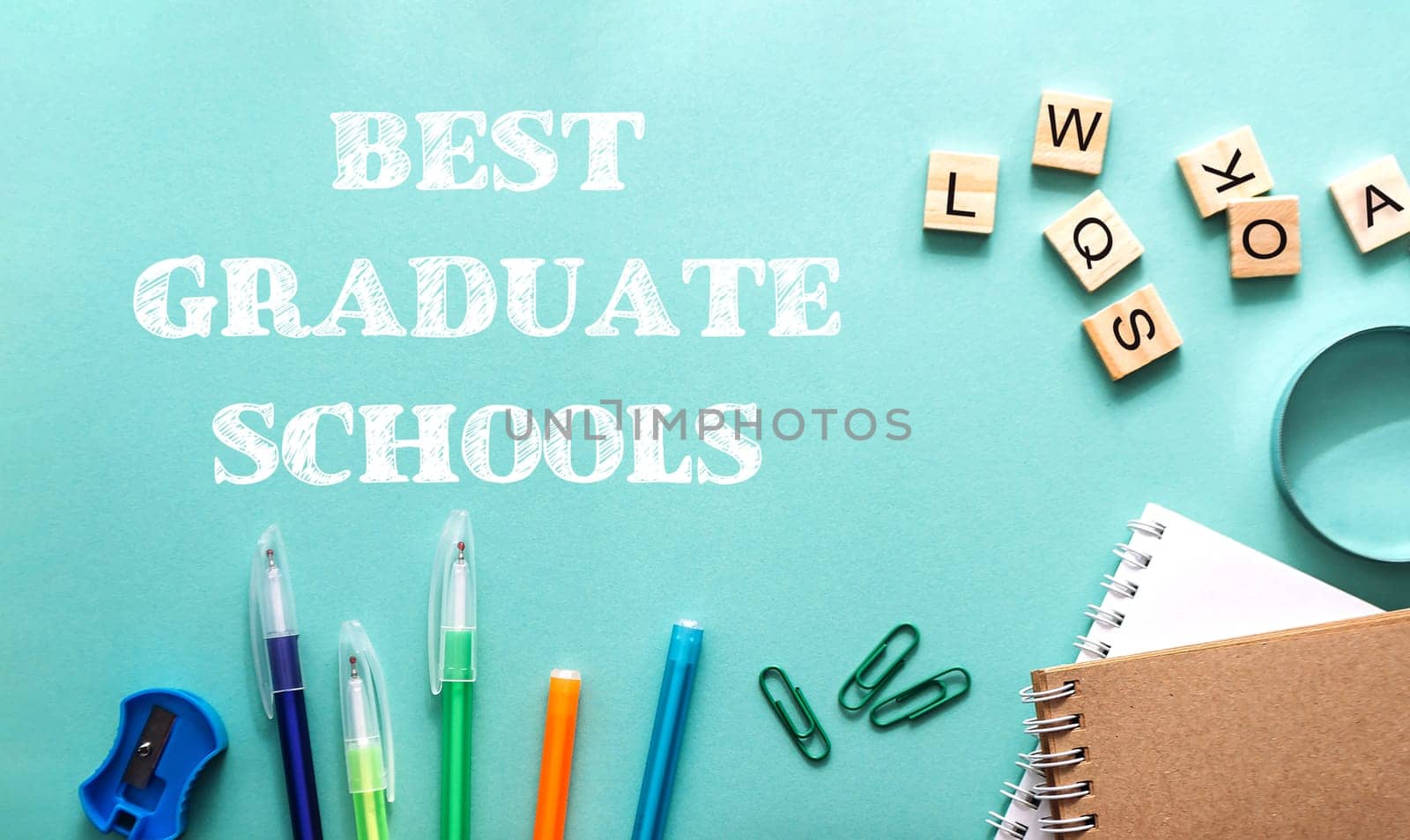 A blue background with a bunch of pens, a pair of scissors, and a stapler. The text reads Best Graduate Schools