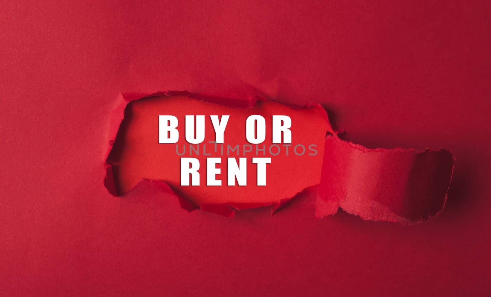 A red background with a white word that says buy or rent. The word is written in a way that it looks like it's peeling off the paper