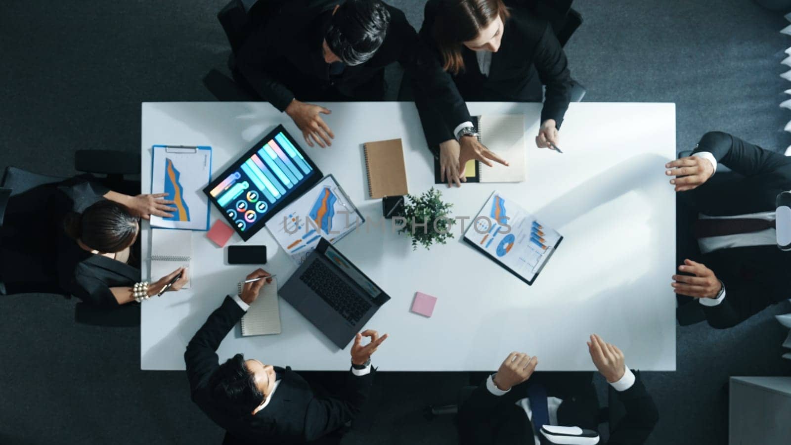 Top view of smart manager give vr head set to businesspeople while businesswoman prepare data analysis or analytic graph in laptop at meeting. Startup team preparing to enter meta verse. Directorate.