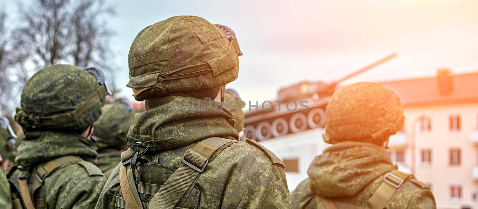Army Soldiers Standing In A Row Holding Guns In Camouflage Uniforms by Hil