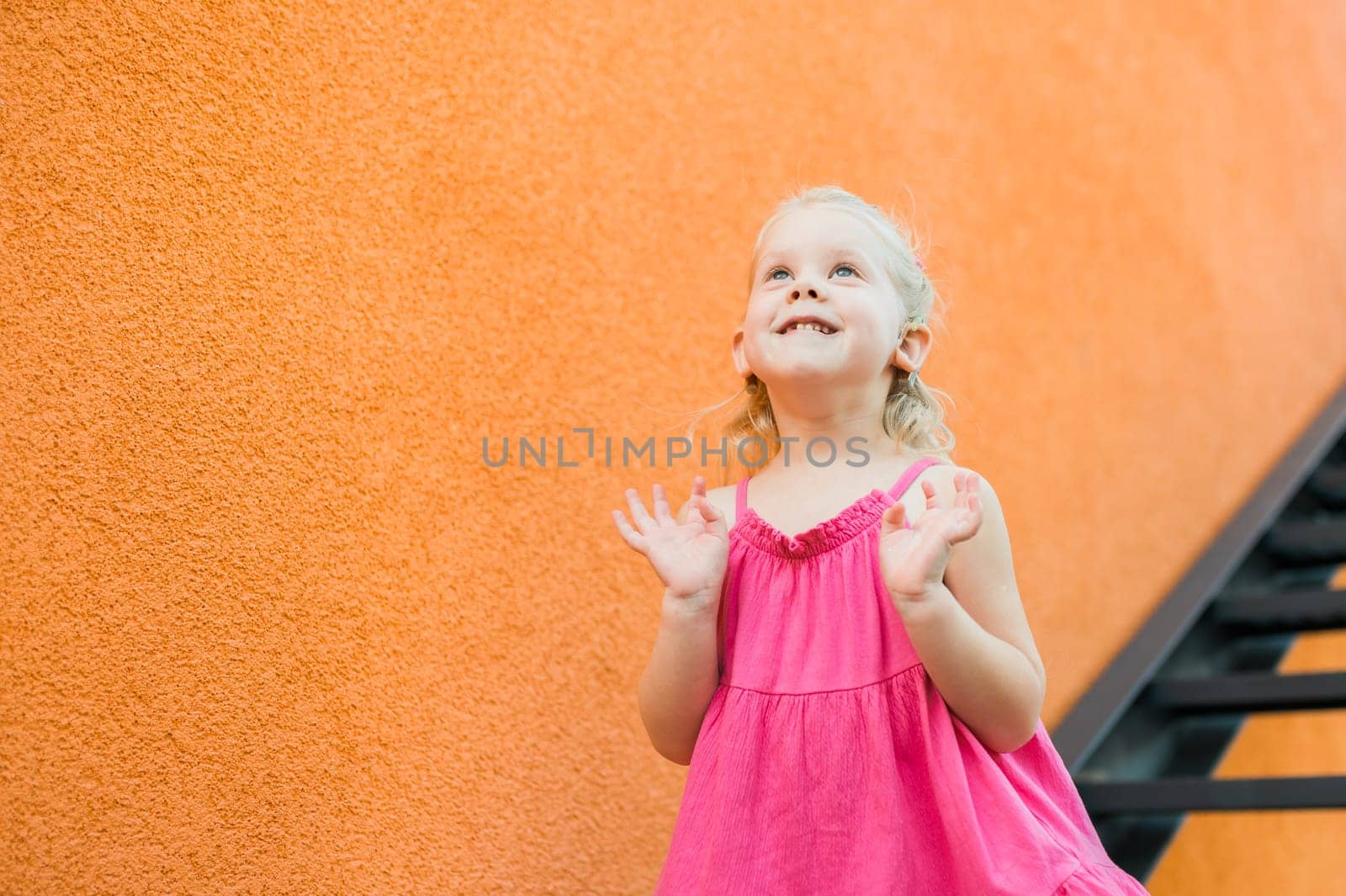 Child with hearing problem and cochlear implant dance in street, deaf kid began to hear. Hearing loss in childhood and treatment concept. Copy space and empty place for text.