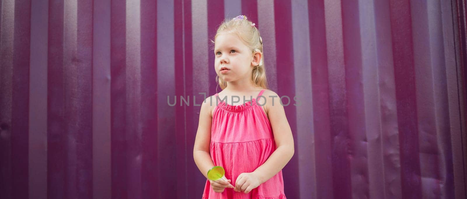 Child walks with cochlear implant system. Installation cochlear implant on child girl ear for restores hearing. Kid hears after hear return to normal. Diversity inclusion