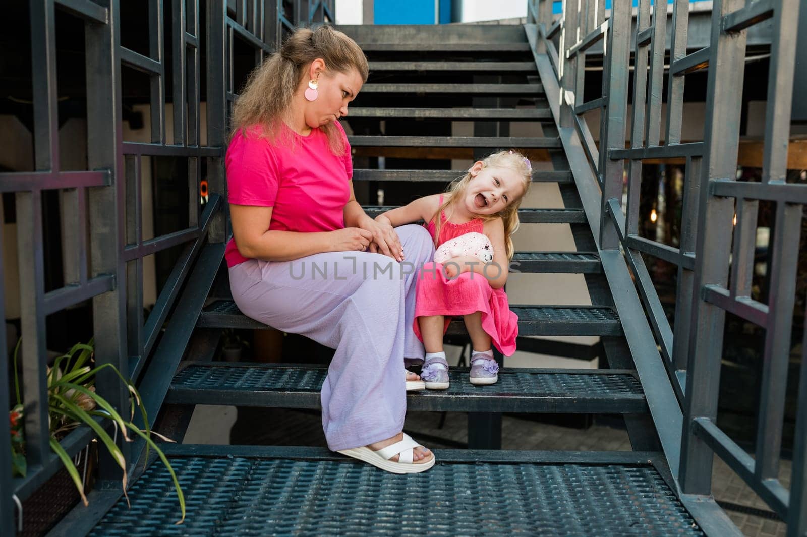 Child girl with cochlear implant with her mother spend time outdoor. Hear impairment and deaf community concept. Deaf and health concept. Diversity and inclusion. Copy space by Satura86