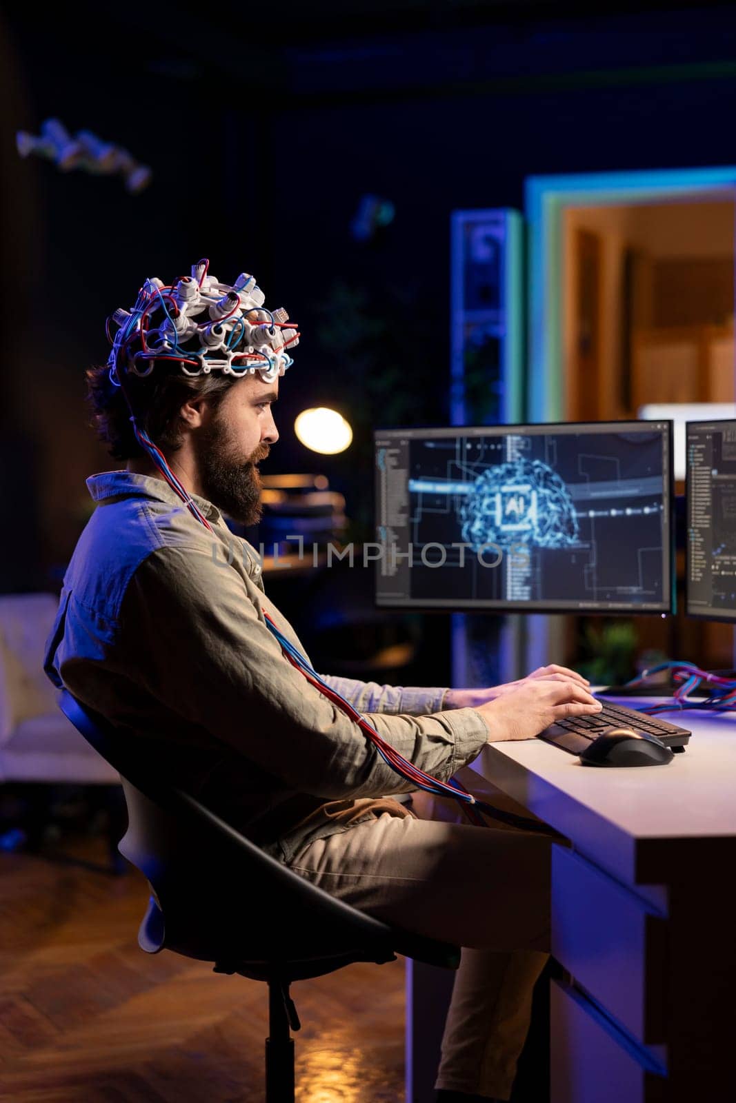 Computer engineer with EEG headset on writing code allowing him to transfer mind into virtual world, becoming one with AI. Crazy scientist using neuroscientific tech to gain superintelligence
