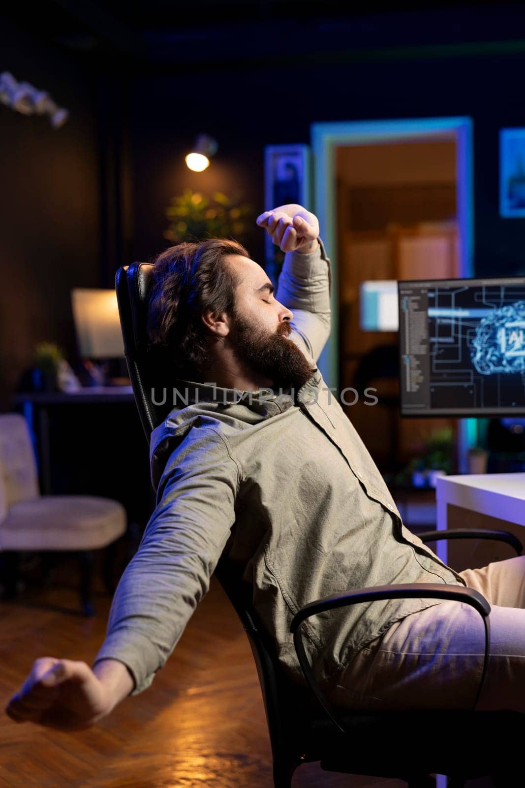 AI software technician stretching after using computer all day by DCStudio