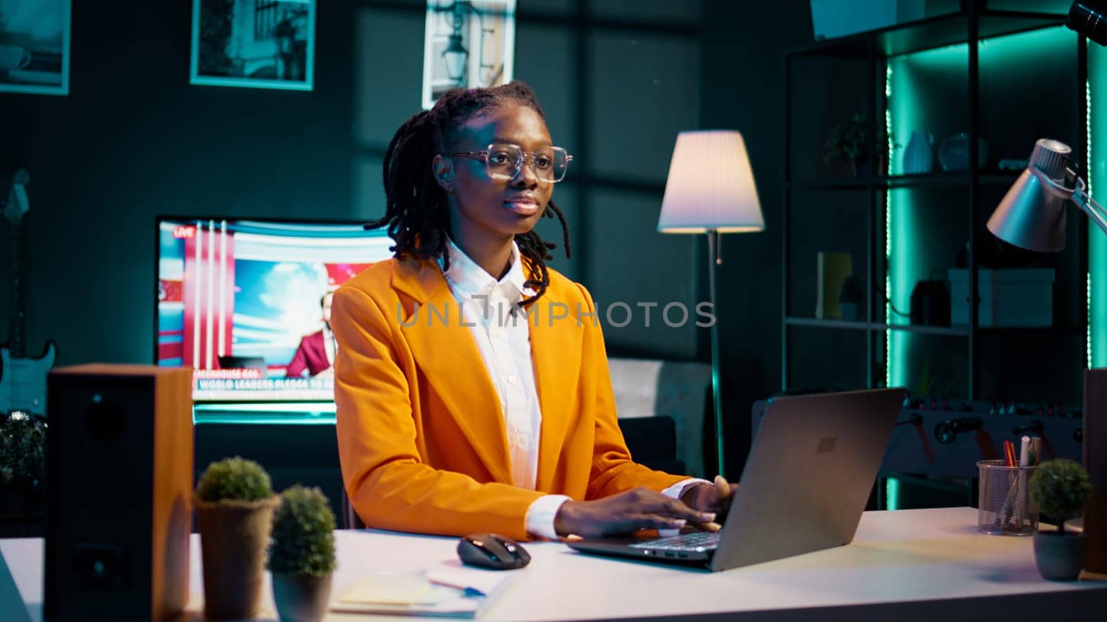 Portrait of dedicated pupil studying class materials and notes to increase knowledge, working from home on her projects. Student researching for assignments using web libraries. Camera B.