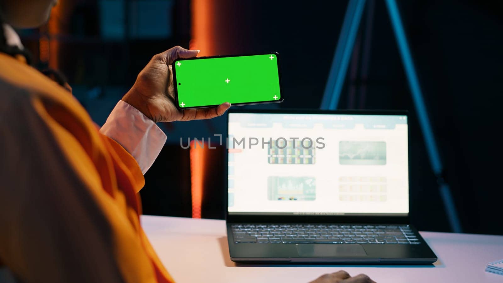 Business student looks at greenscreen on phone app and learning to use tax service software, money management. Young woman holding device with isolated mockup display, e learning. Camera A.