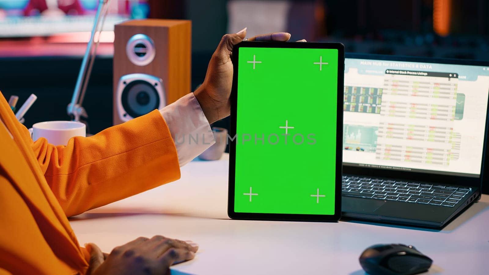 African american girl holding tablet with greenscreen layout, conducting data analysis for financial or economics courses. Student uses isolated mockup display on device, work from home. Camera A.