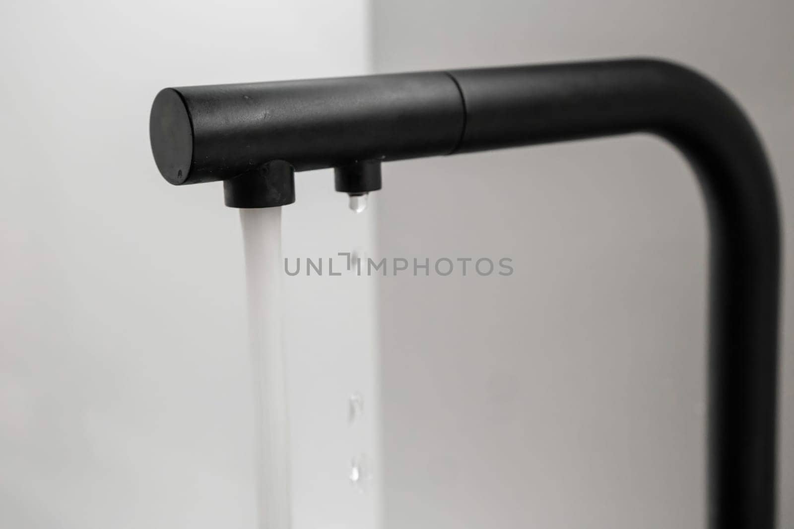 Water flows from the black tap in the kitchen.