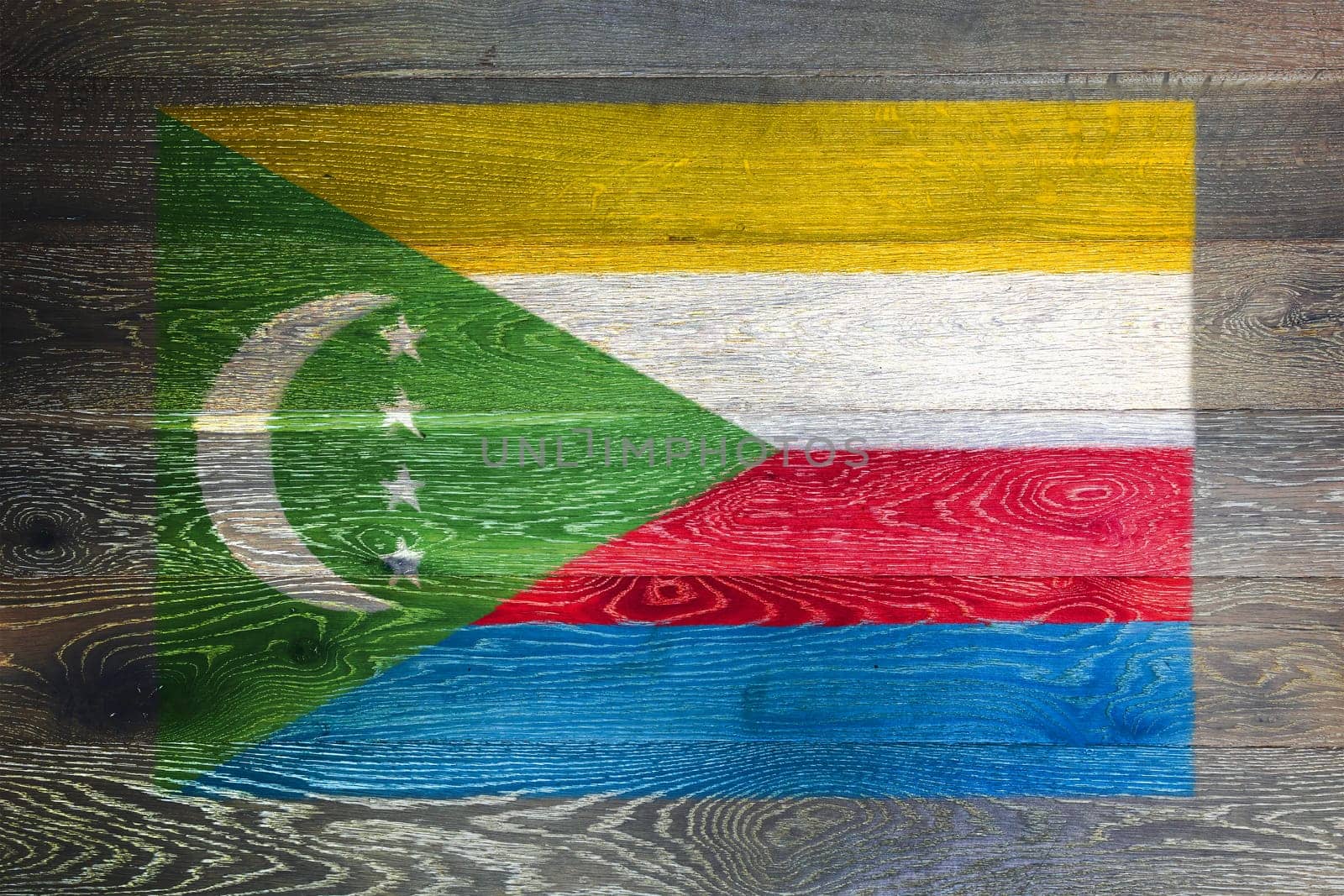 Comoros flag on rustic old wood surface background by VivacityImages