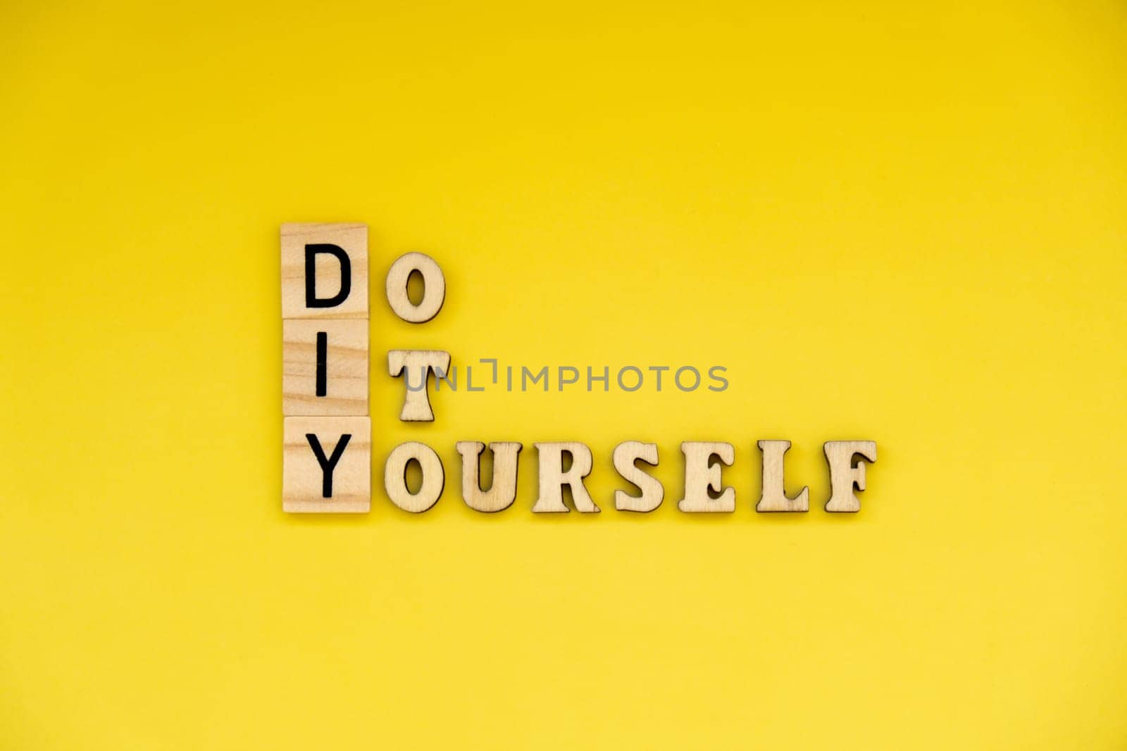 DIY Do It Yourself inscription on yellow background. Handmade home repair decorating handicraft. Tactile creative hobby concept by anna_stasiia