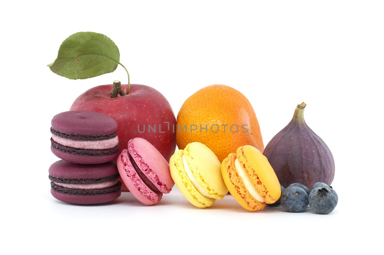 Colorful French macarons and assortment of fruits isolated on white background. Full depth of field