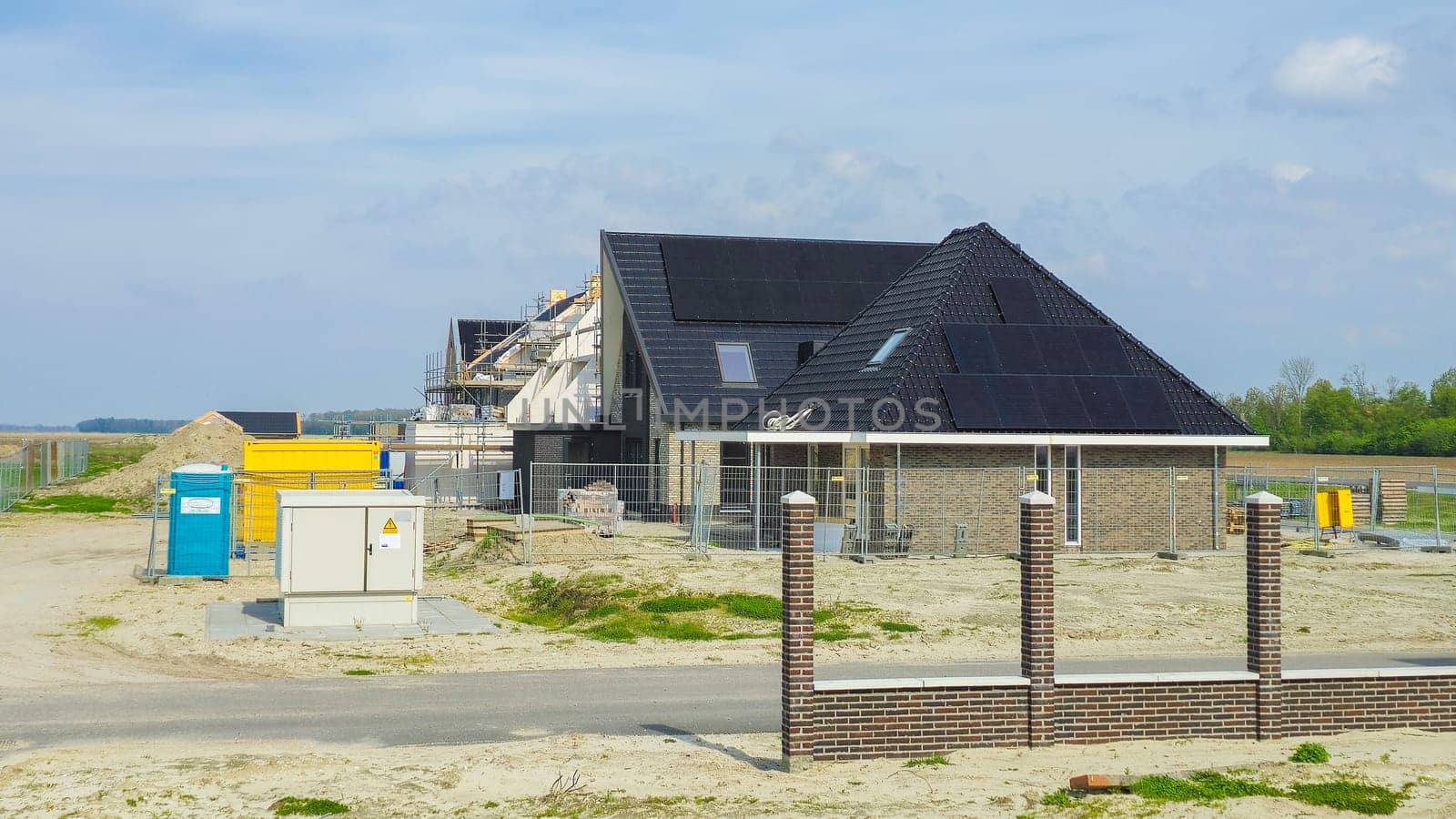 construction site of a new Dutch Suburban area with modern family houses, newly built modern family homes in the Netherlands with solar panels