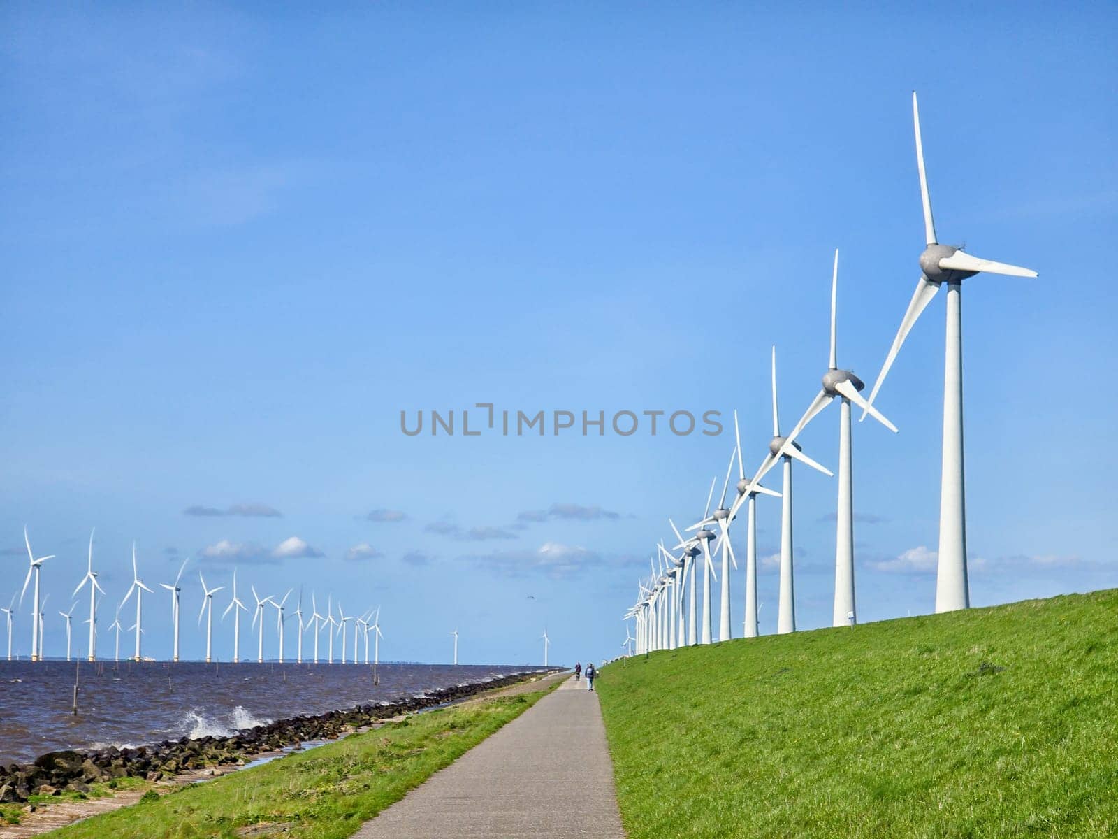 offshore windmill park and a blue sky, windmill park in the ocean. Netherlands Europe by fokkebok