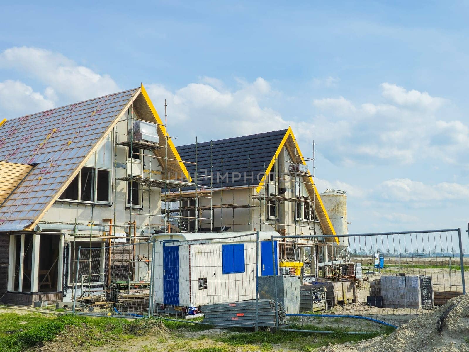 construction site of a new Dutch Suburban area with modern family houses, newly built modern family homes in the Netherlands during construction