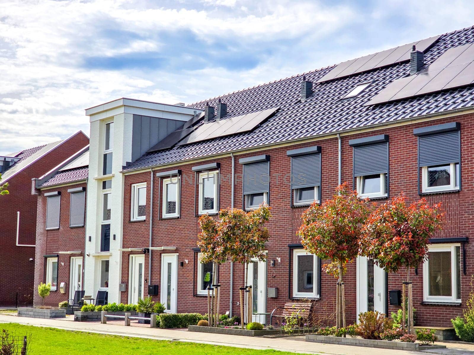 Newly built houses with black solar panels on the roof in the Netherlands