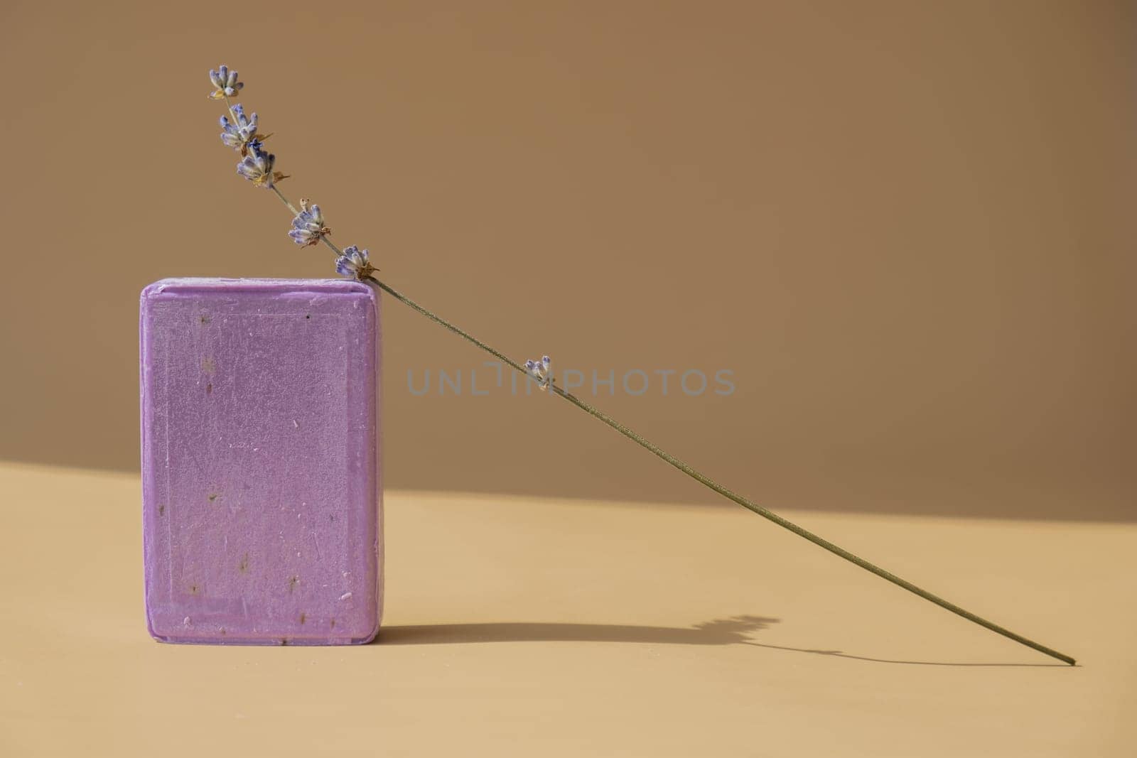 Lavender soap on beige background with copy space for your text. Advertisement template mock up. Skincare homemade natural cosmetic concept. Organic dry lavender flower by anna_stasiia