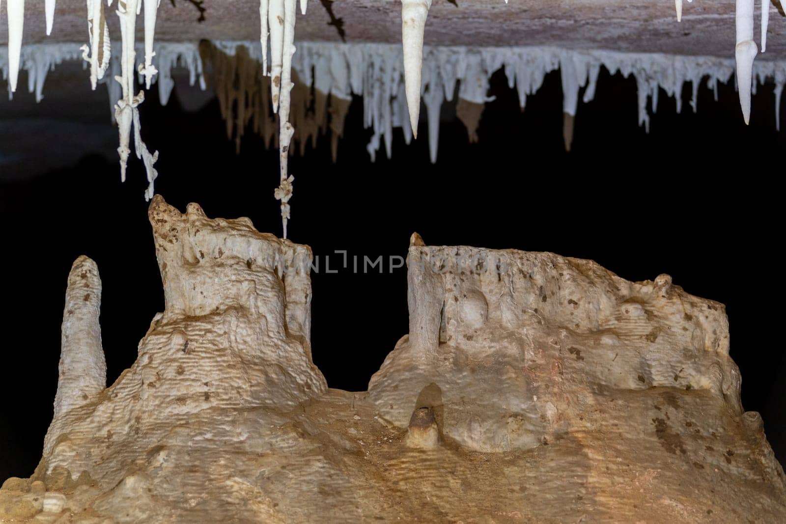 Mysterious Stalagmites and Stalactites in a Dark Cave by FerradalFCG