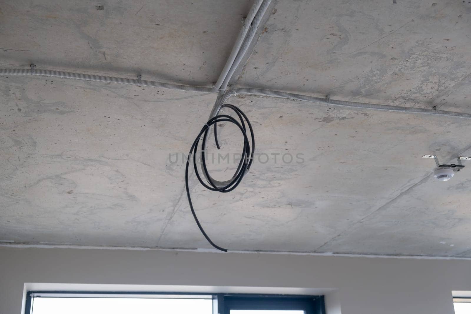 Apartment renovation. Electrical wiring. Wiring electrical cables on wall by AnatoliiFoto