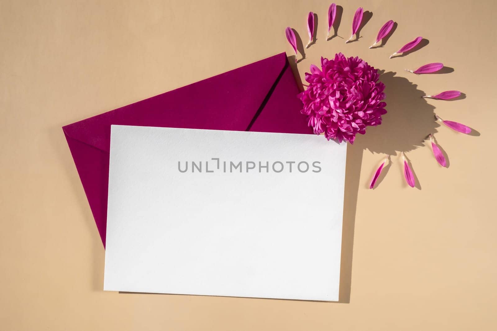 Composition with empty paper note and envelope beautiful spring pink flowers on beige background. Mockup card invitation greeting card postcard copy space template by anna_stasiia