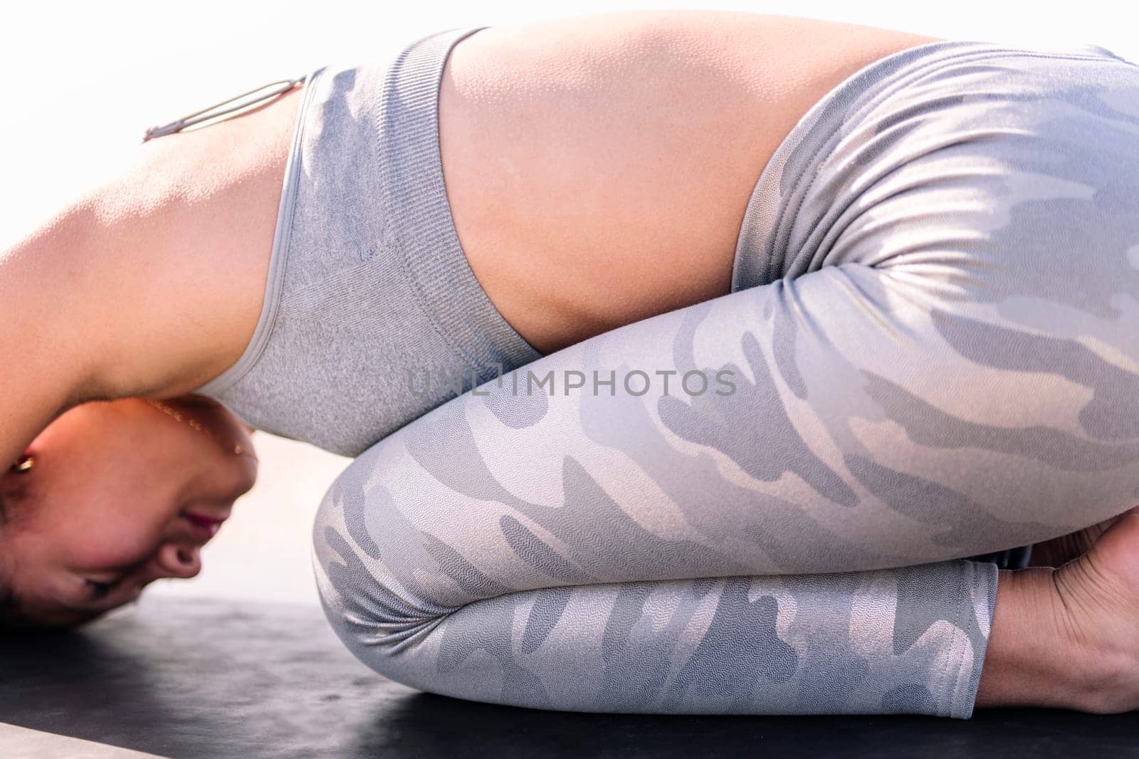 unrecognizable young asian woman in sportswear practicing yoga, relaxation and healthy lifestyle concept