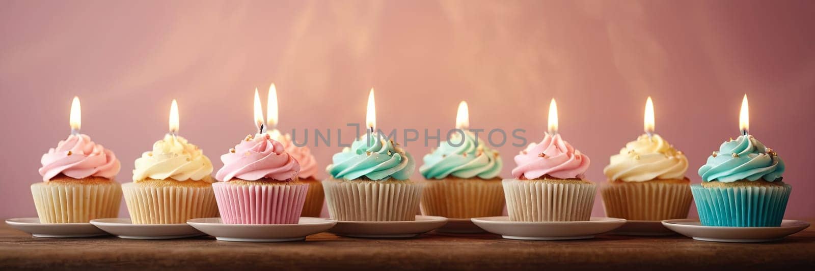 Colorful cupcakes with lit candles are displayed against a pink background, indicating an indoor celebration event marking of joy and celebrating. with free space.