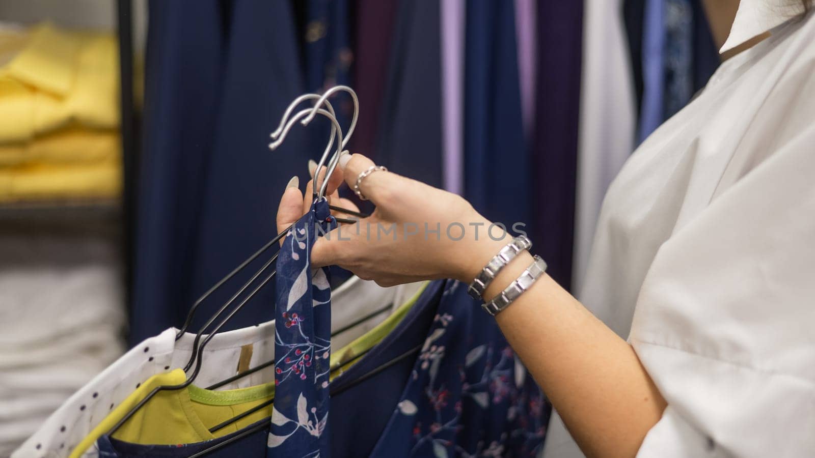 Close-up of woman's hands with hangers in a clothing store