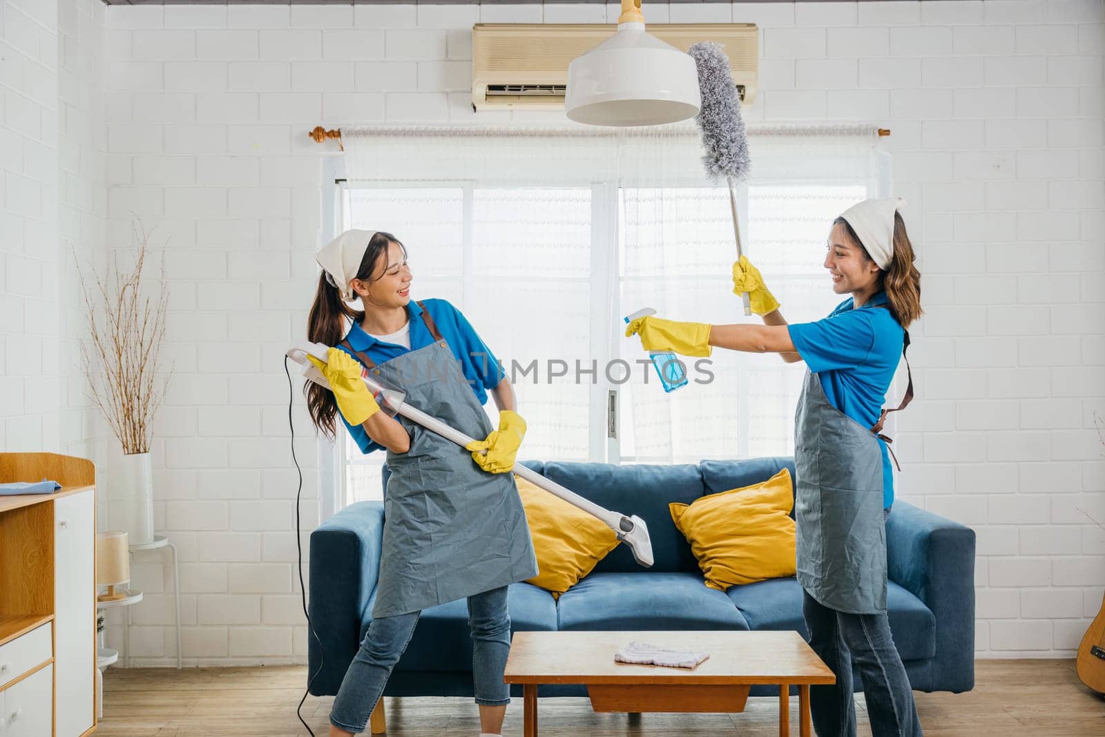 Vacuum guitar fun, Asian maid playful routine husband humor evident. Singing dancing joyfully. Music-filled service brings excitement to household cleaning. Cleaning is fun