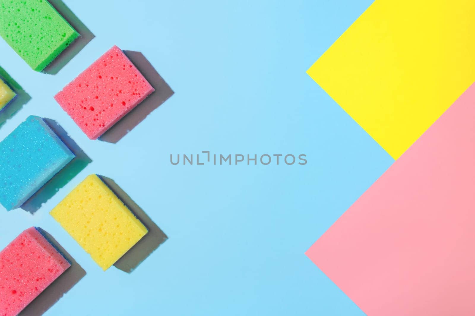 Bright and Colorful Cleaning Sponges: A Flat Lay for Cleaning Services or Housekeeping, copy space. Flat Lay of Cleaning Sponges: A Colorful, Bright and Eye-Catching Display for Cleaning Services.